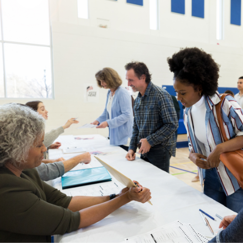 Poll worker helping people at the polls